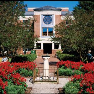Front entrance of Swem Library with the sun dial in the foreground