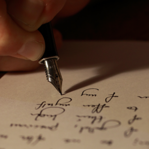 Closeup of a hand using a fountain pen to write