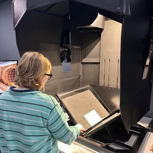 A student scanning the Monitor Journal