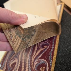 corner of a fore edge painting revealed by fanning the book pages