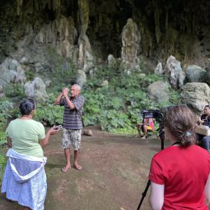 Image of an anthropologist filming an interview during field research
