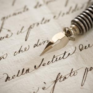 Handwritten letter with vintage fountain pen on top